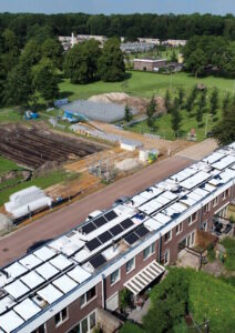 Zonnecollectoren op de woningen en op de school wekken warmte op en verwarmen de seizoensbuffer